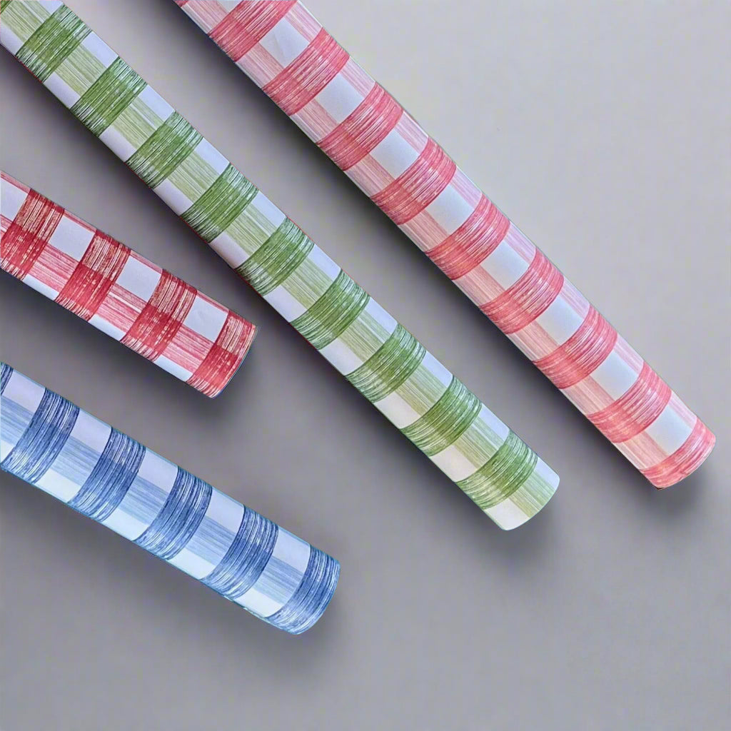 Four rolls of gingham wrapping paper in pink, green, red, blue