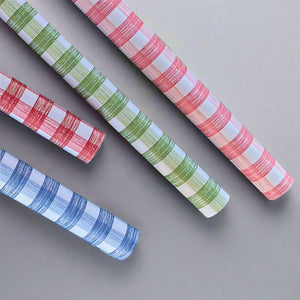 Four rolls of gingham wrapping paper in pink, green, red, blue
