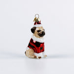 Glass Pug ornament of a pug dog wearing a red santa sweater on a white background