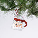 Glass Santa Mug with Glitter Candy Cane Christmas Ornament hanging in a branch