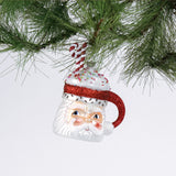 Glass Santa Mug with Glitter Candy Cane Christmas Ornament hanging in a branch