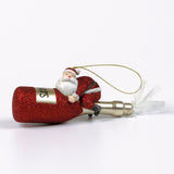 a santa riding a red champagne bottle ornament against a white background