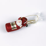 a santa riding a red champagne bottle ornament against a white background