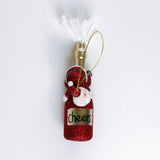 a santa riding a red champagne bottle ornament against a white background