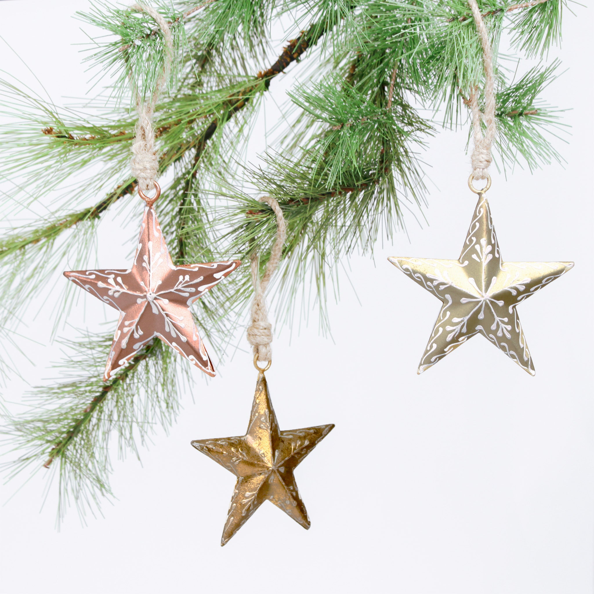 Star-shaped Christmas ornaments hanging on a tree branch