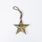 gold star ornament with floral pattern on a white background