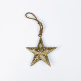 gold star ornament with floral pattern on a white background