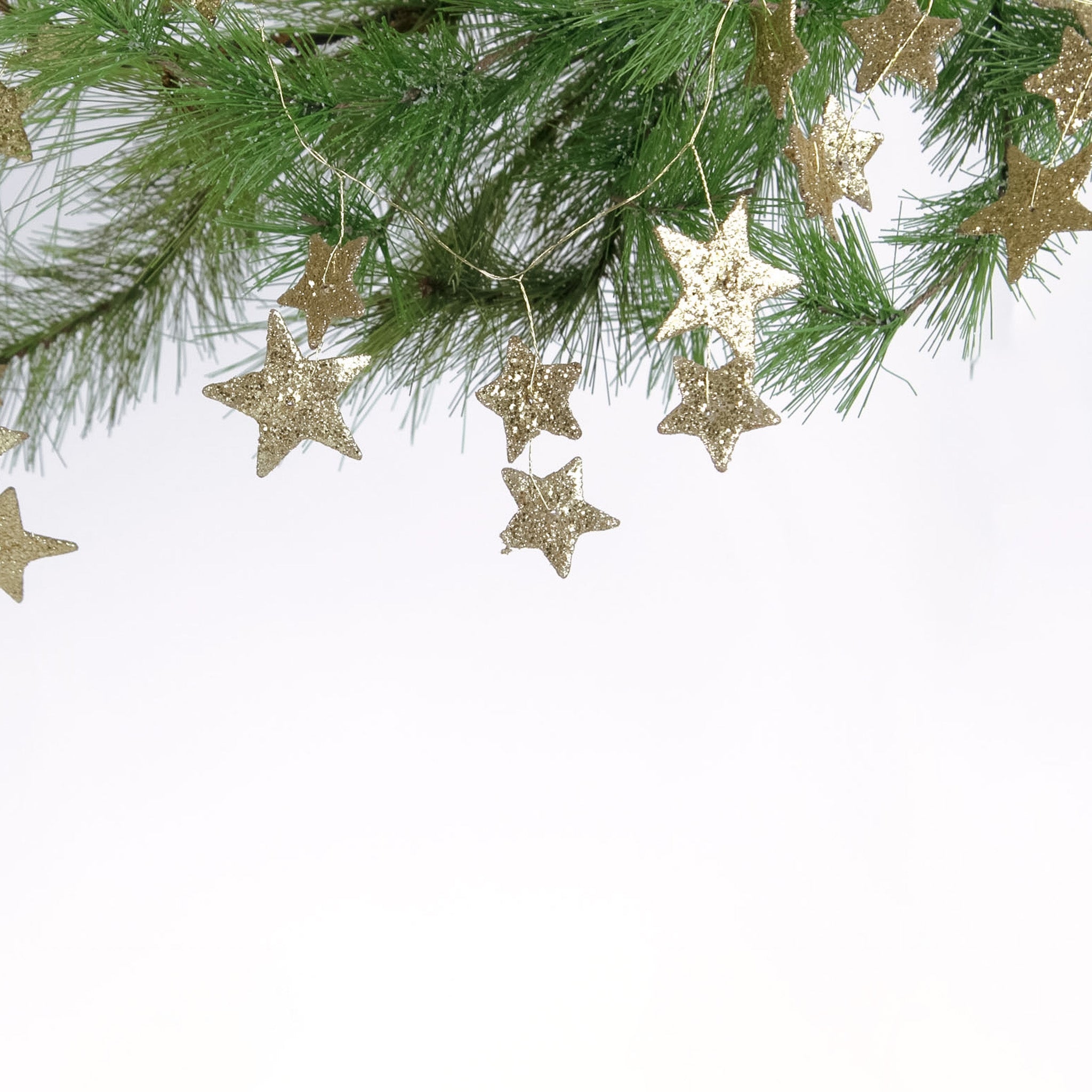 Gold stars Christmas Garland designed on a pine tree branch