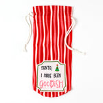 red and white striped drawstring bag with a “Santa, I have been goodish” label on the front