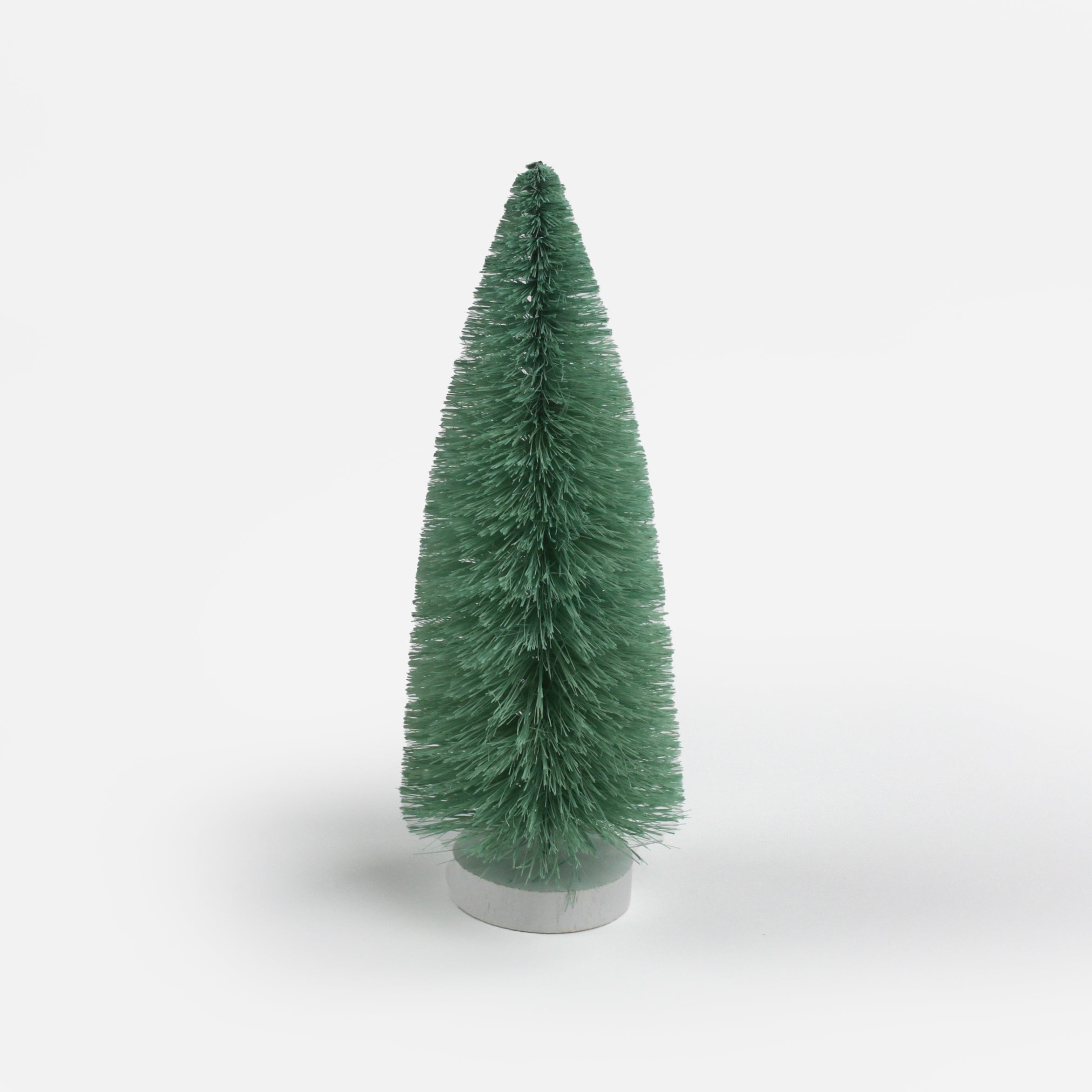 Green Bottle Brush Christmas Tree table decorations in different tones against a white  background. 