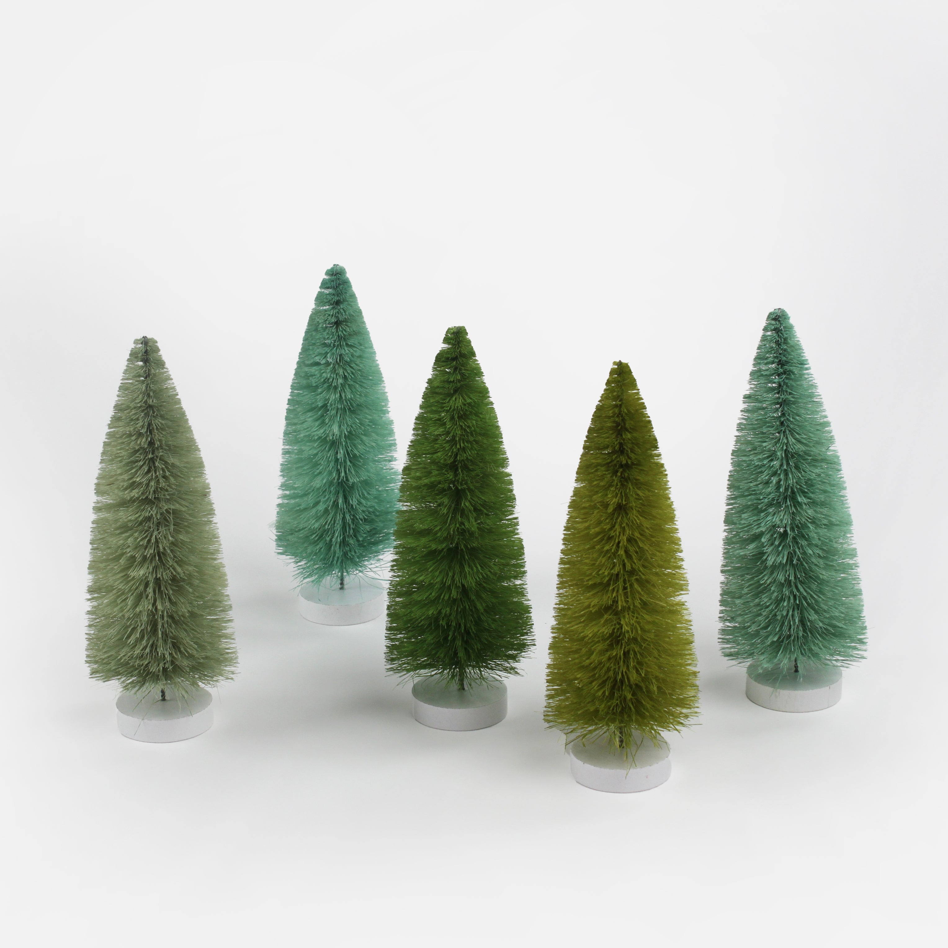 a set of 5, Green Bottle Brush Christmas Tree table decorations in different tones against a white  background. 