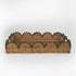 Rattan tray with scalloped edge and green trim on a white background