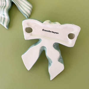 green and white ceramic bow back detail