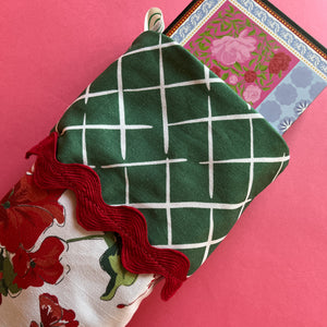 The green folded top of a red christmas stocking