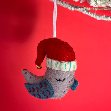 a grey and blue sleeping bird wearing a santa hat felt chrismtas ornament