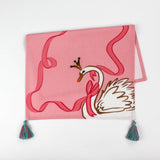 Christmas tea towel designed with a white swan with a golden crown and pink ribbon on a pink background 