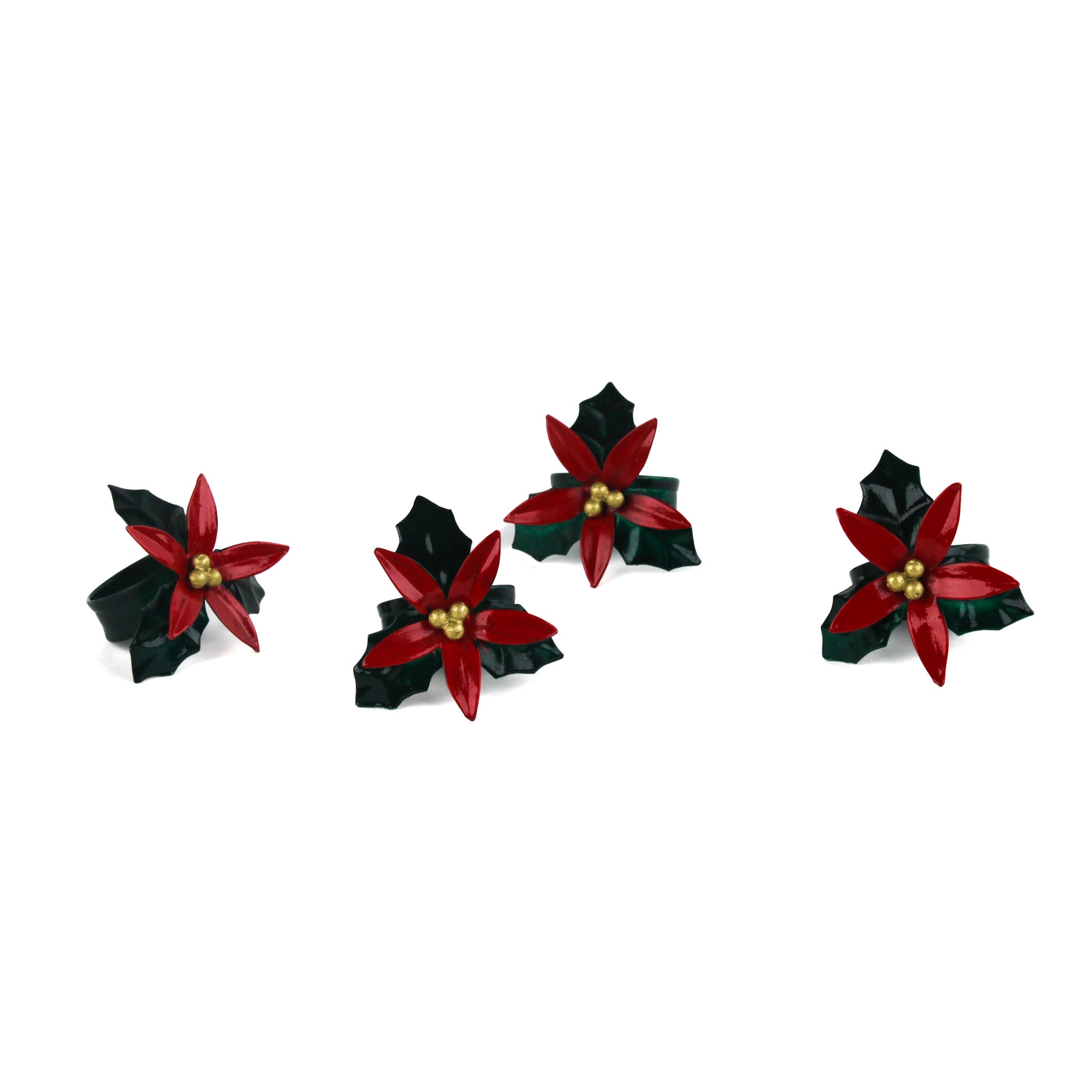 Set of four hand-painted metal poinsettia napkin rings with red flowers and green leaves.