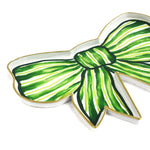 Close-up angled view of a green and white striped bow-shaped tray with gold edging.