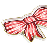 Close-up of a red and white striped bow-shaped decorative tray with gold trim.