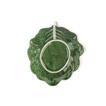 back of a ceramic green cabbage leaf plate on a white background.