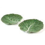 a ceramic green cabbage leaf plate on a white background.
