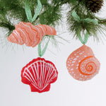 Handcrafted Pink Orange Shells Felt Christmas Ornaments featuring coral spiral, conch, and red scallop shell designs with green gingham ribbons.