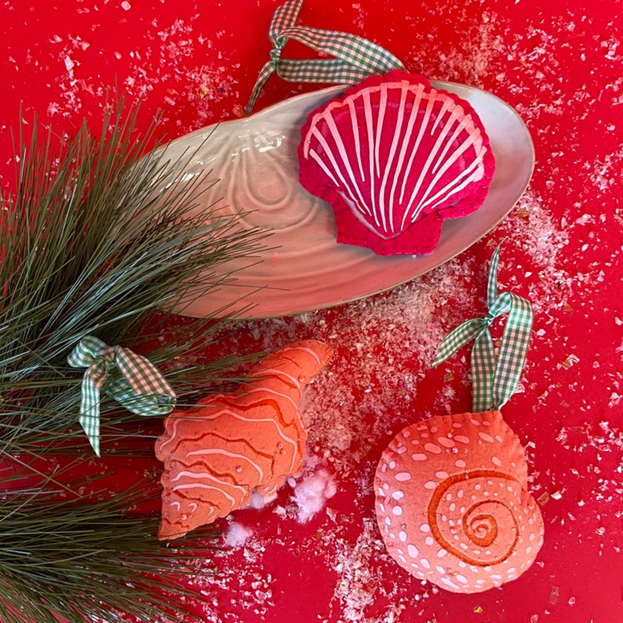 Handcrafted Pink Orange Shells Felt Christmas Ornaments featuring coral spiral, conch, and red scallop shell designs with green gingham ribbons.