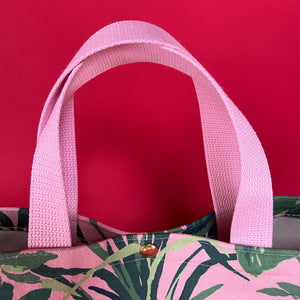 Handle detail of the small Jungle Road canvas tote in pink and green