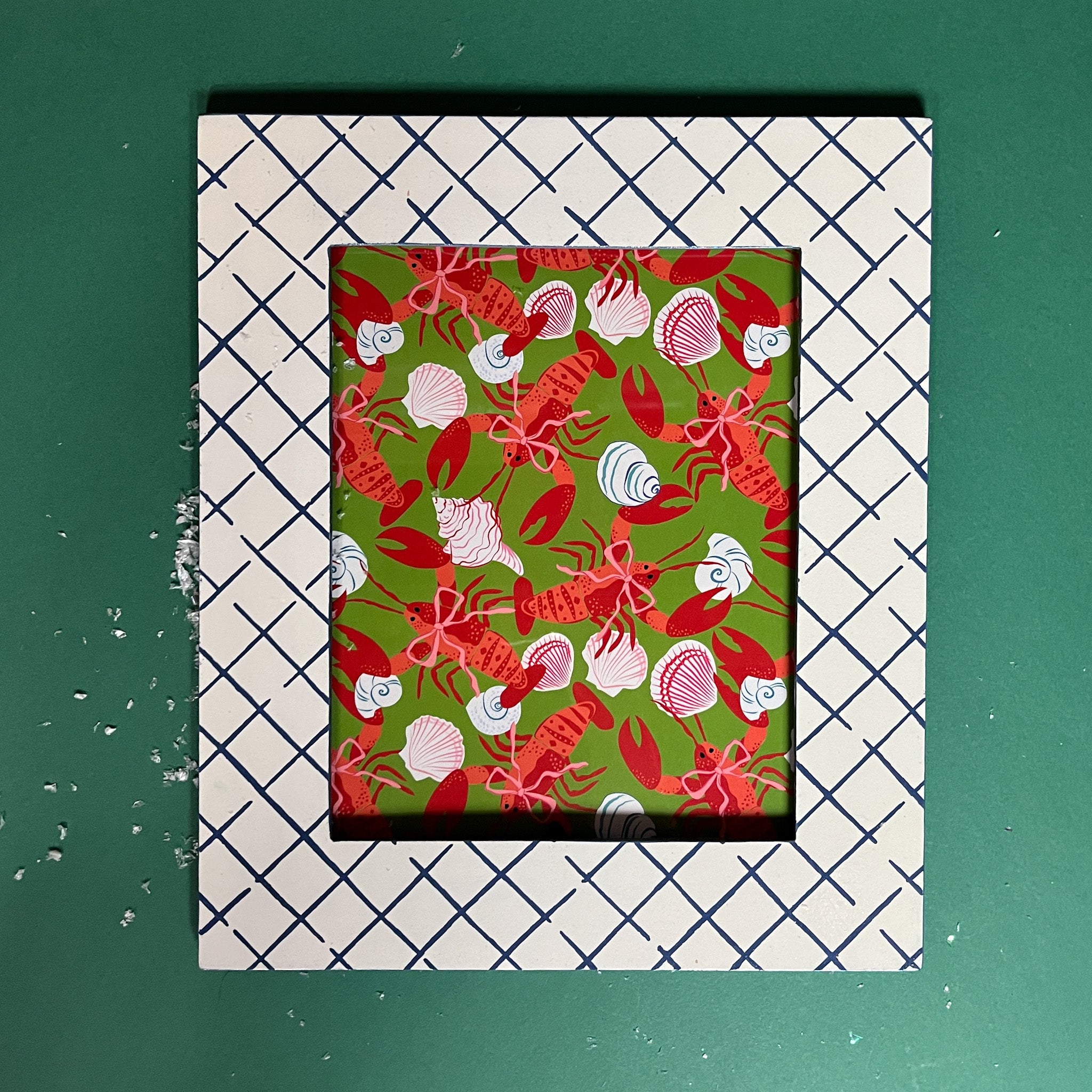 A blue and white photo frame featuring a trellis pattern from madcap cottage