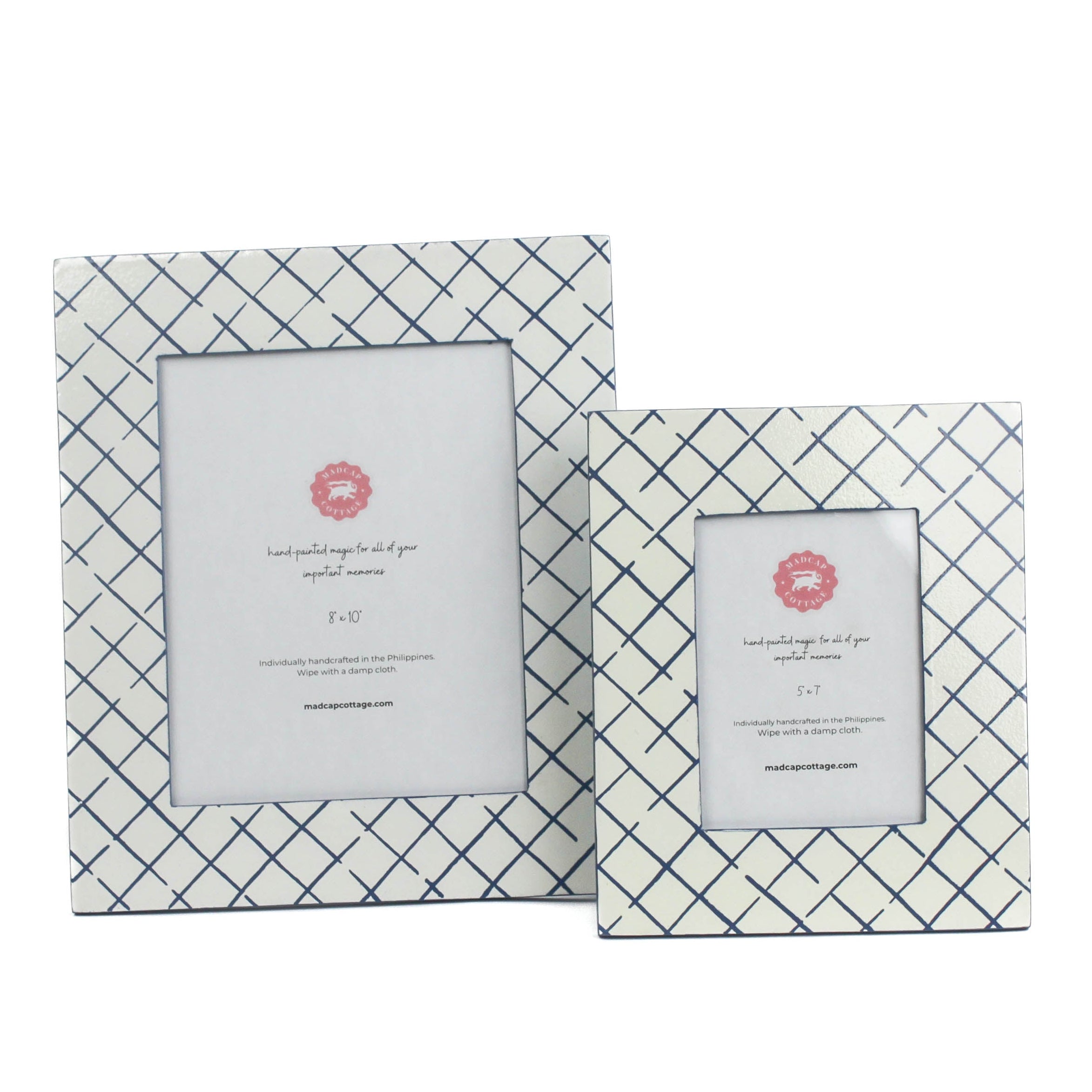 Two Bahama Court white and blue hand painted photo frames on a white background