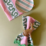 Harbor Trail Bahama pink cloth dinner napkins with a green ric rac trimfrom madcap cottage with a gold bunny napkin ring
