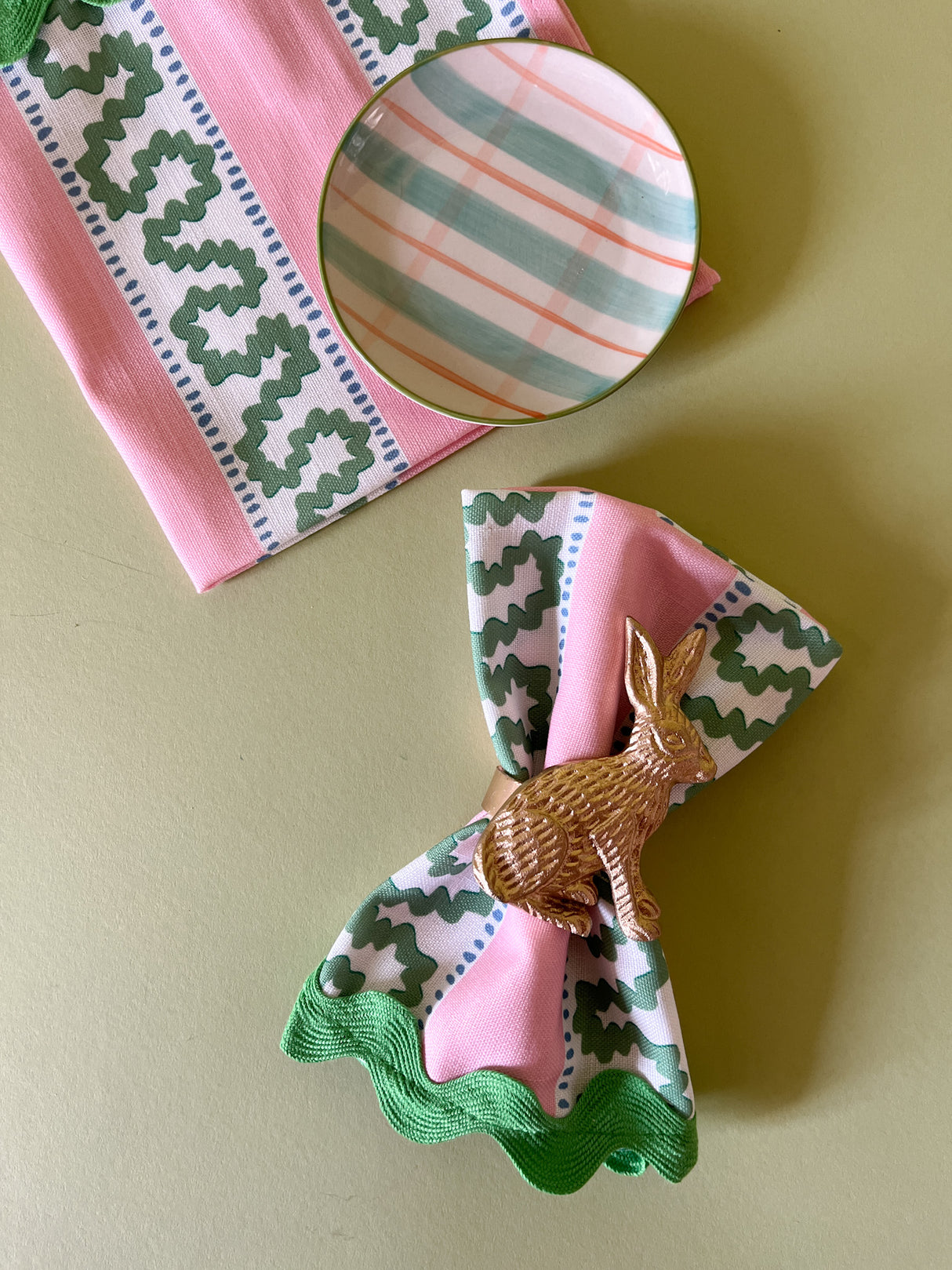 Harbor Trail Bahama pink cloth dinner napkins with a green ric rac trimfrom madcap cottage with a gold bunny napkin ring