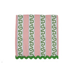 Pink tea towel with vertical green patterned stripes and scalloped green trim along the bottom edge.