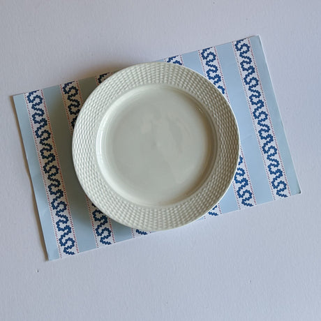 blue paper placemats featuring a striped pattern from Madcap Cottage