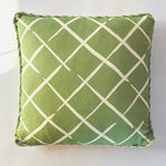 Green lattice accent pillow with cream crosshatch pattern and decorative cord trim