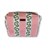 A Bahama pink Harbor Trail Large Cosmetics Bag with a toiletry and makeup items inside, set against a white background.