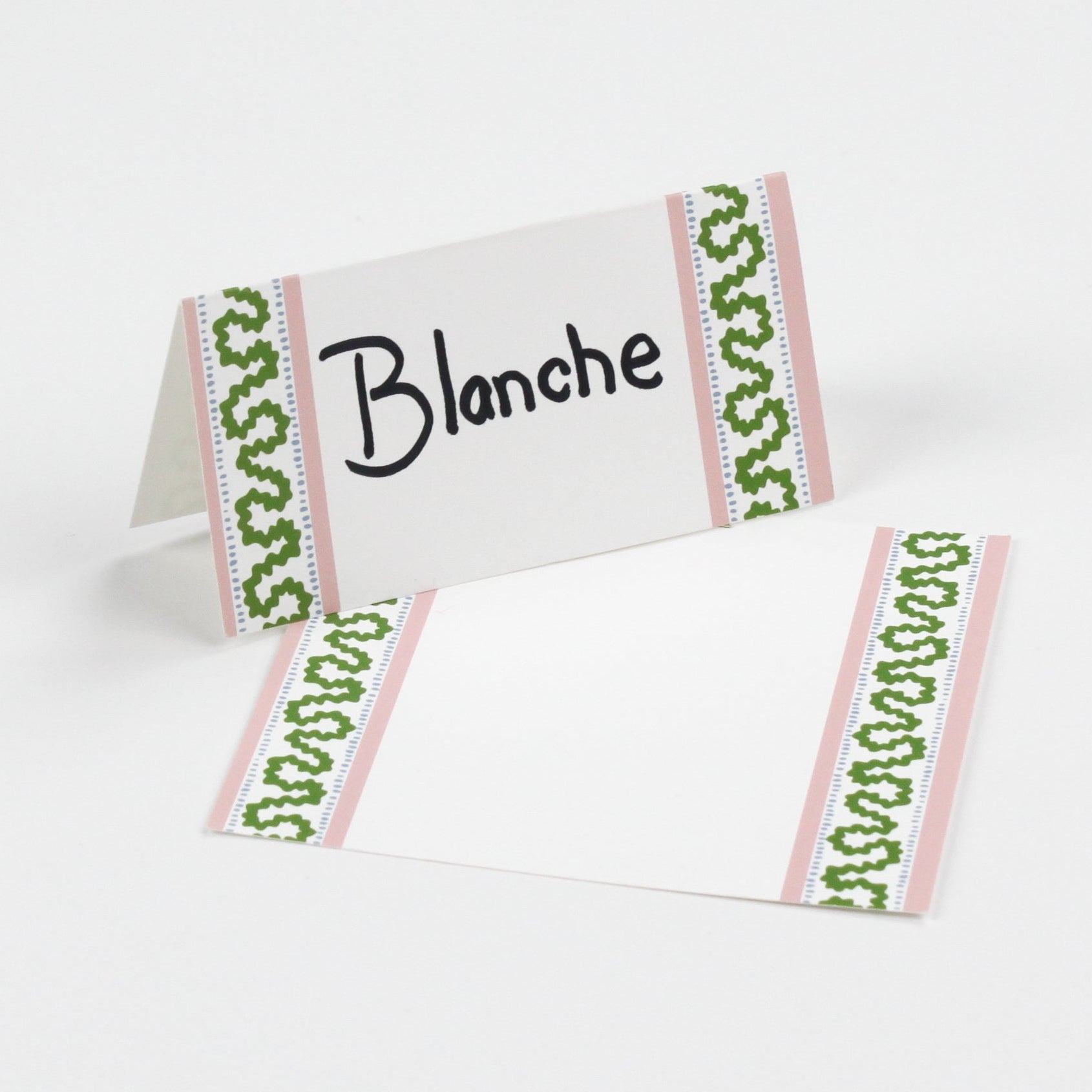 Harbor Trail Paper Place Cards in green and pink displayed on white background