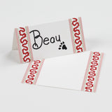 Harbor Trail Paper Place Cards in pink and red displayed on a white background