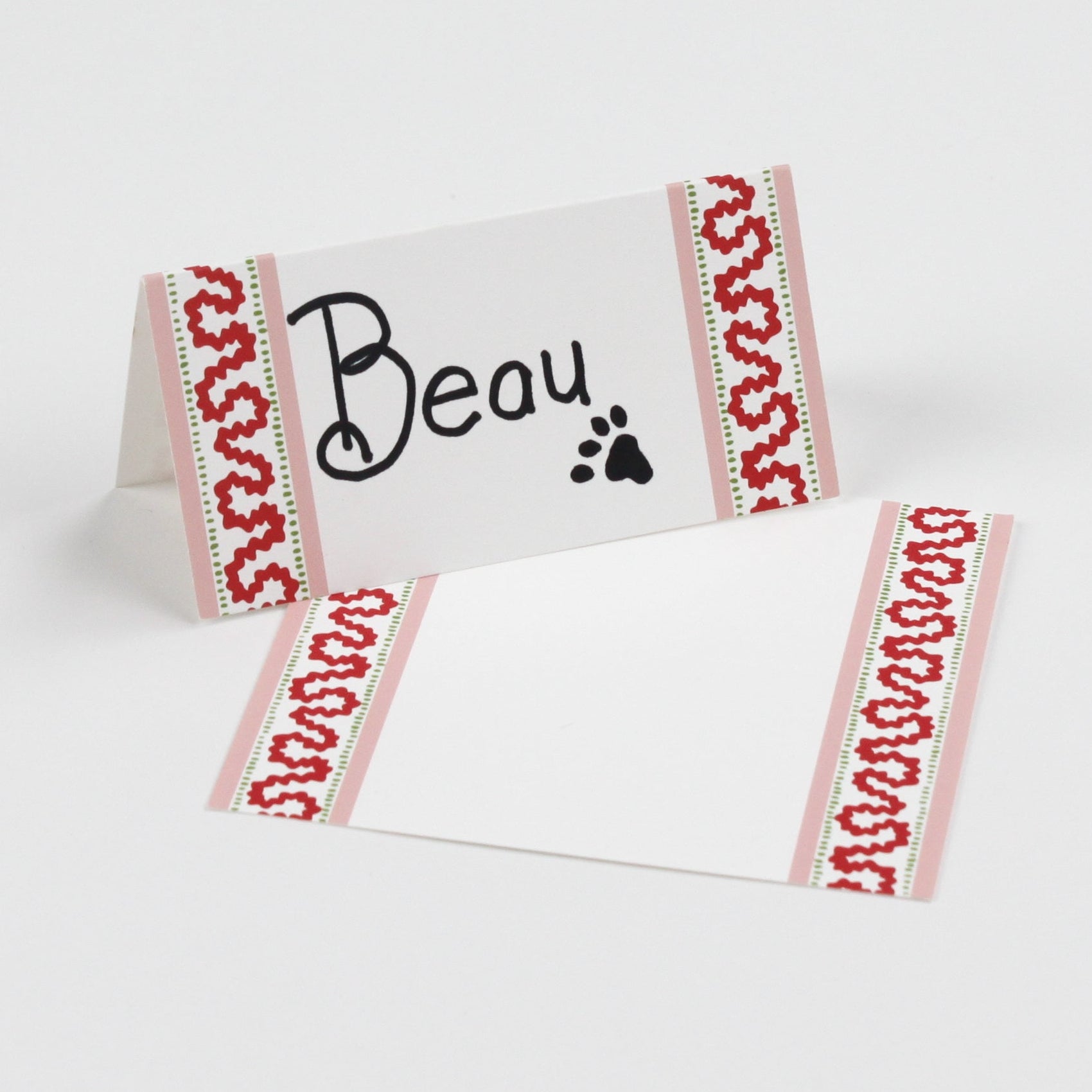 Harbor Trail Paper Place Cards in pink and red displayed on a white background