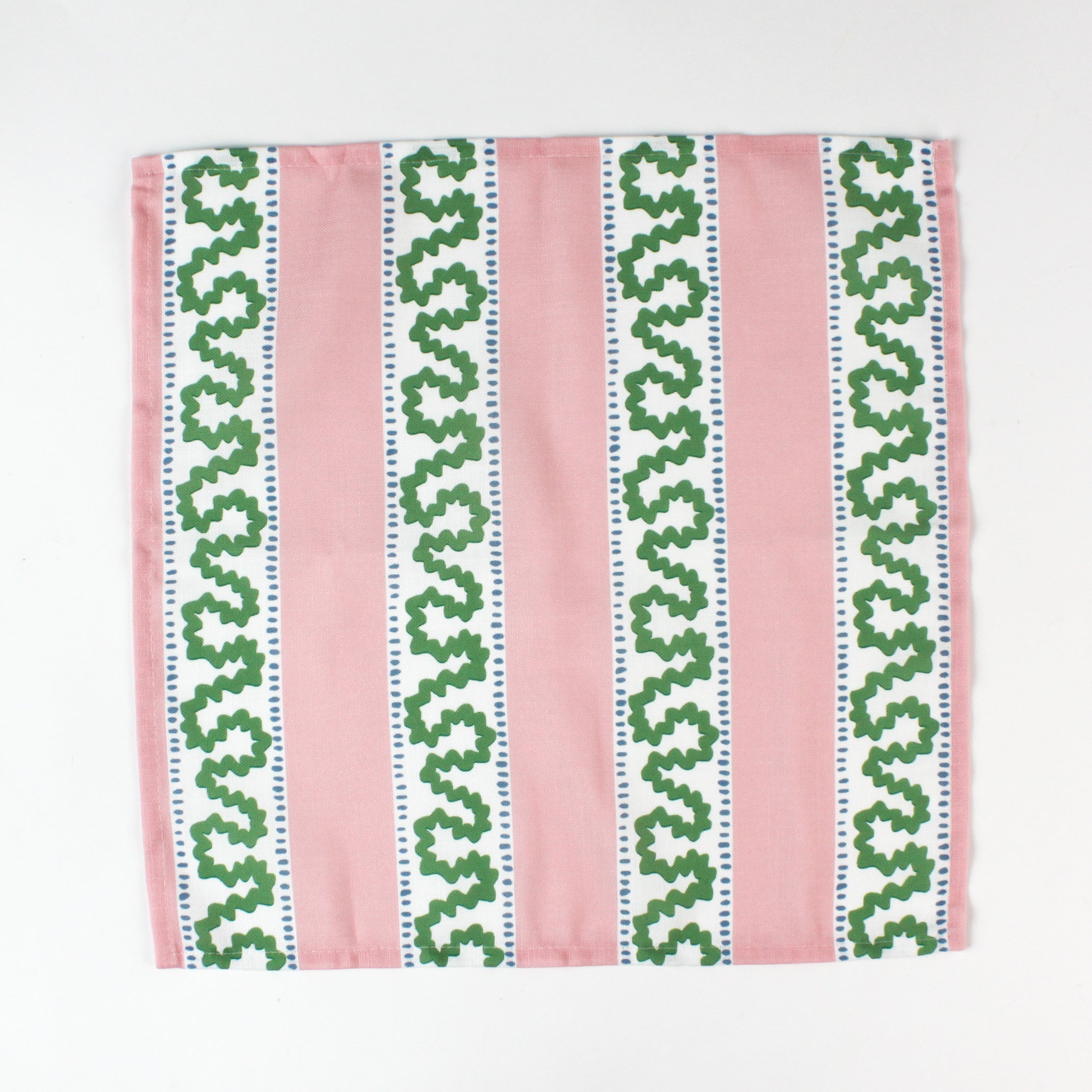 Green and light green geometric arrow print cloth napkin folded open to show pattern, modern cotton table linen.