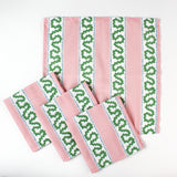Set of handmade cloth napkins with pink stripes and green wavy trim pattern, displayed with matching dinner napkins for table decor.