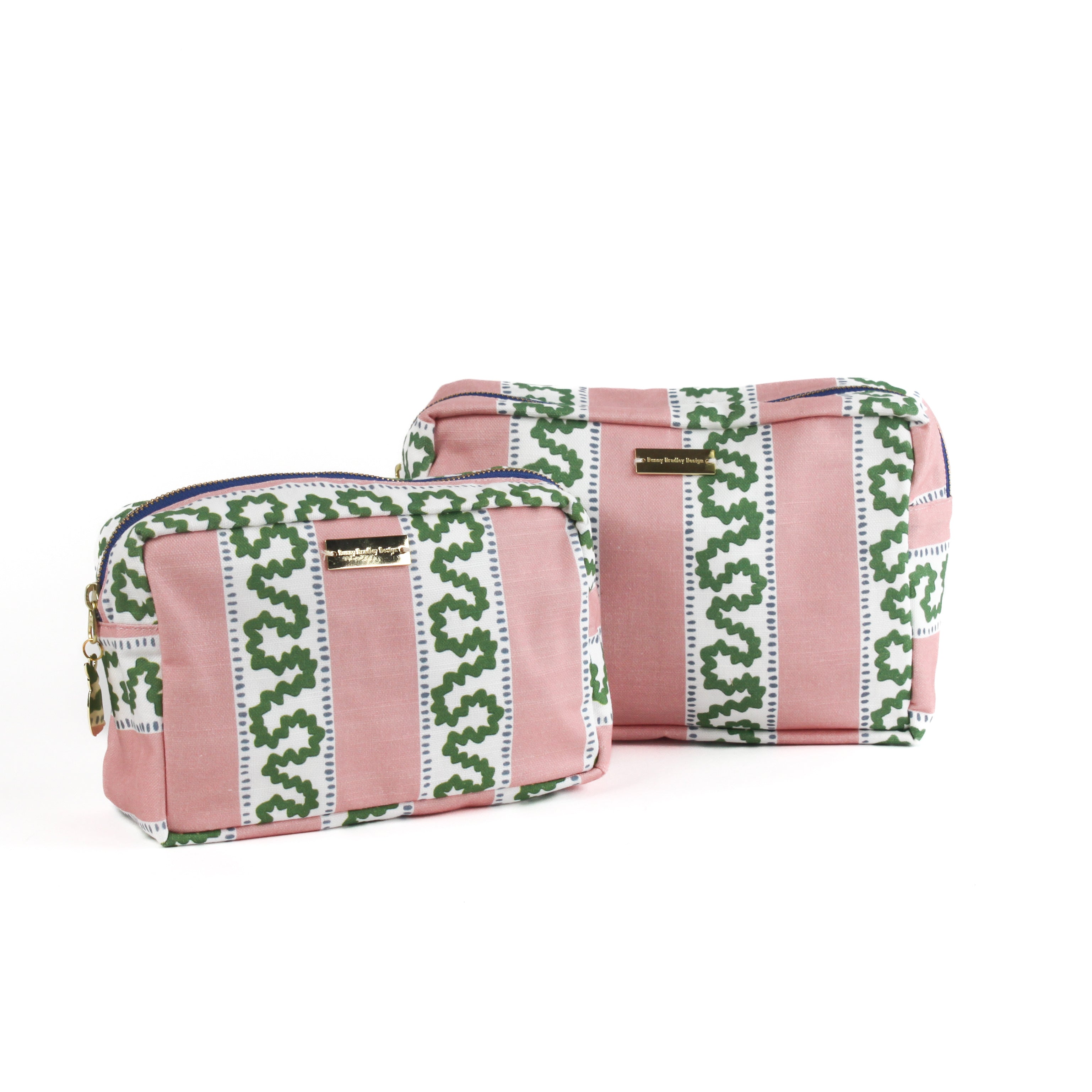 Large and medium Bahama pink Harbor Trail Large Cosmetics Bag with a toiletry and makeup items inside, set against a white background.