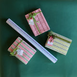 Four wrapping paper in fancy stripe patterns of assorted colors.