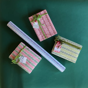 Four wrapping paper in fancy stripe patterns of assorted colors.