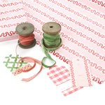 red and pink striped wrapping paper in fancy stripe patterns with ribbons and assorted gift tags