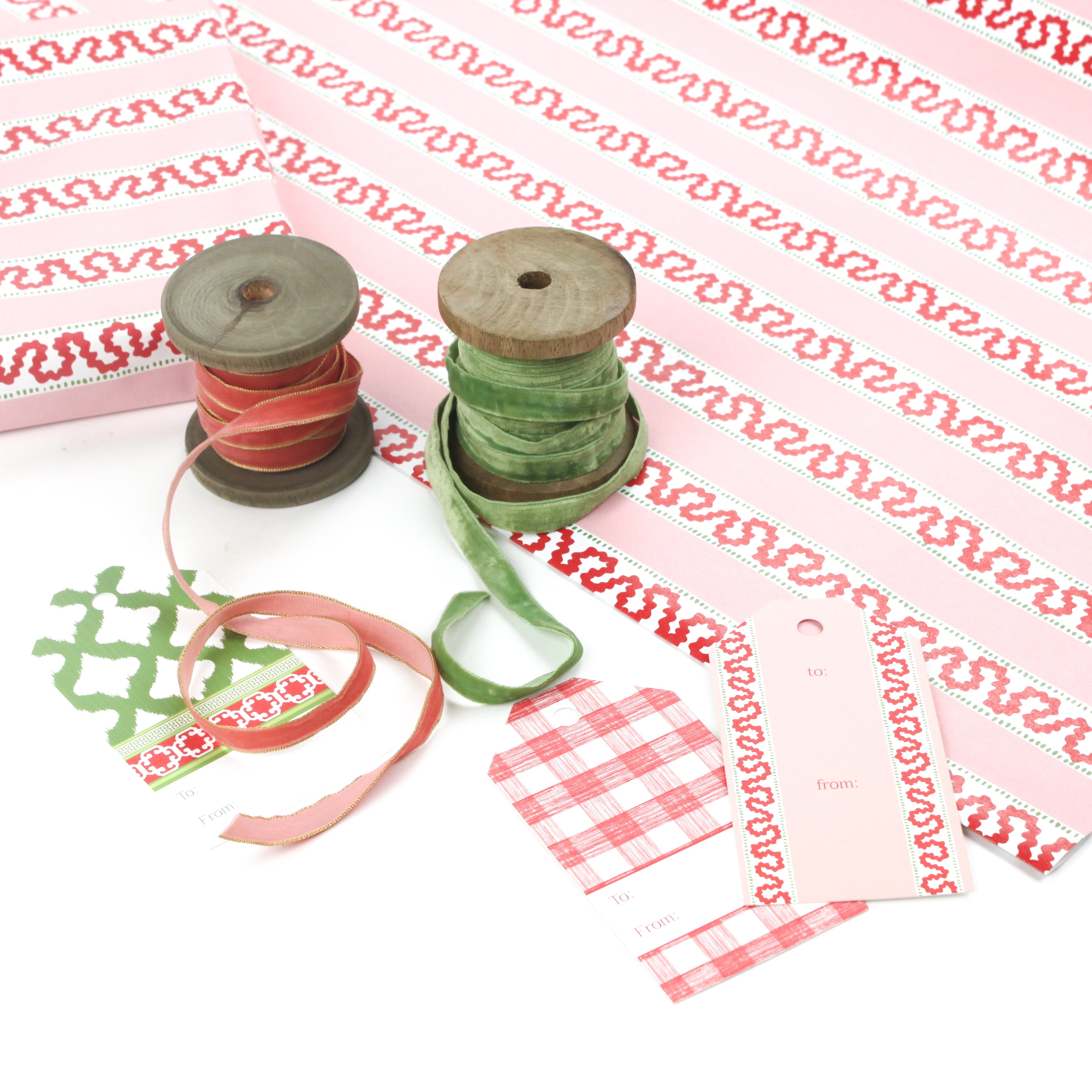red and pink striped wrapping paper in fancy stripe patterns with ribbons and assorted gift tags