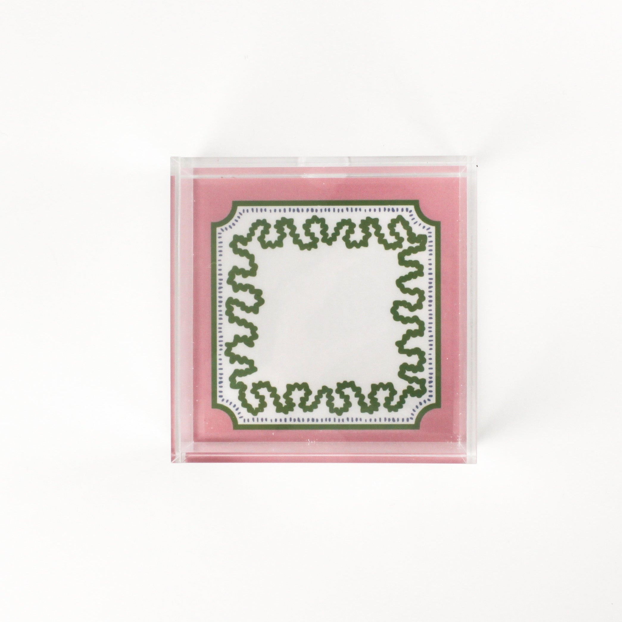 a square acrylic tray with a pink and green base featuring a green squiggle motif around the border.