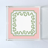 a square acrylic tray with a pink and green base featuring a green squiggle motif around the border.