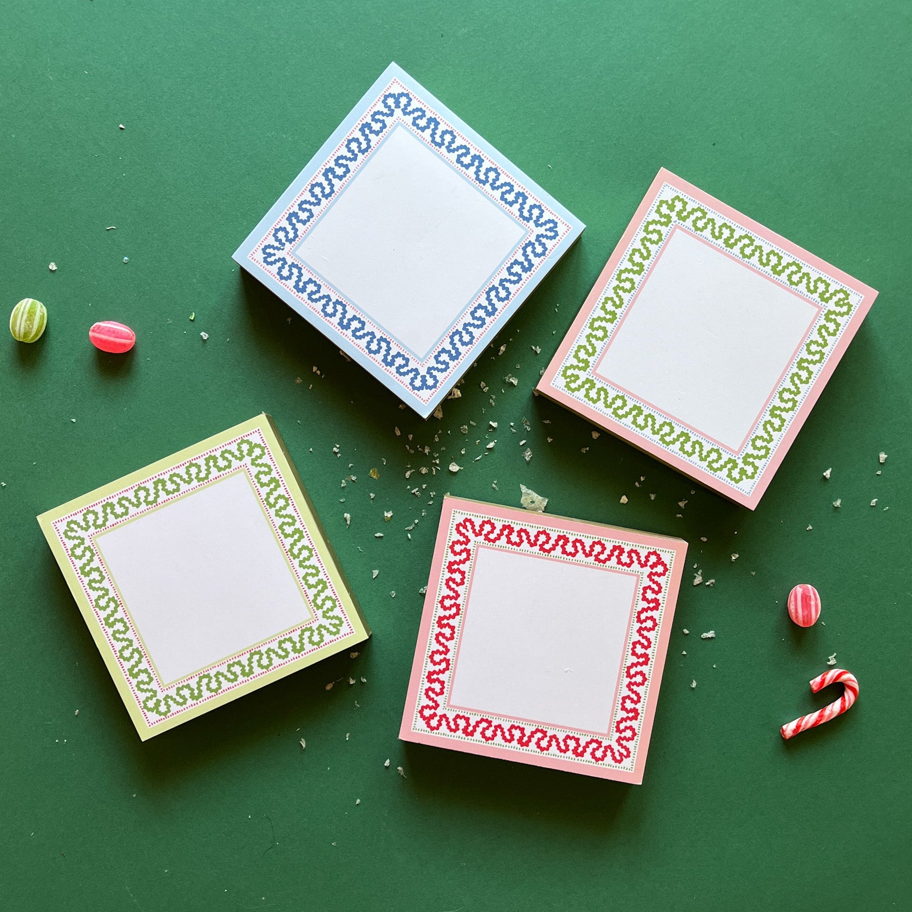 Square notepads with a decorative border and a placeholder graphic icon on a green background.