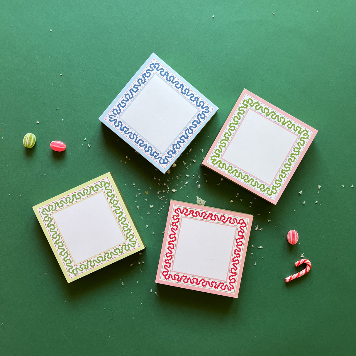 Square notepads with a decorative border and a placeholder graphic icon on a green background.